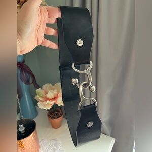 Adjustable length thick black leather belt with heavy silver-toned hardware